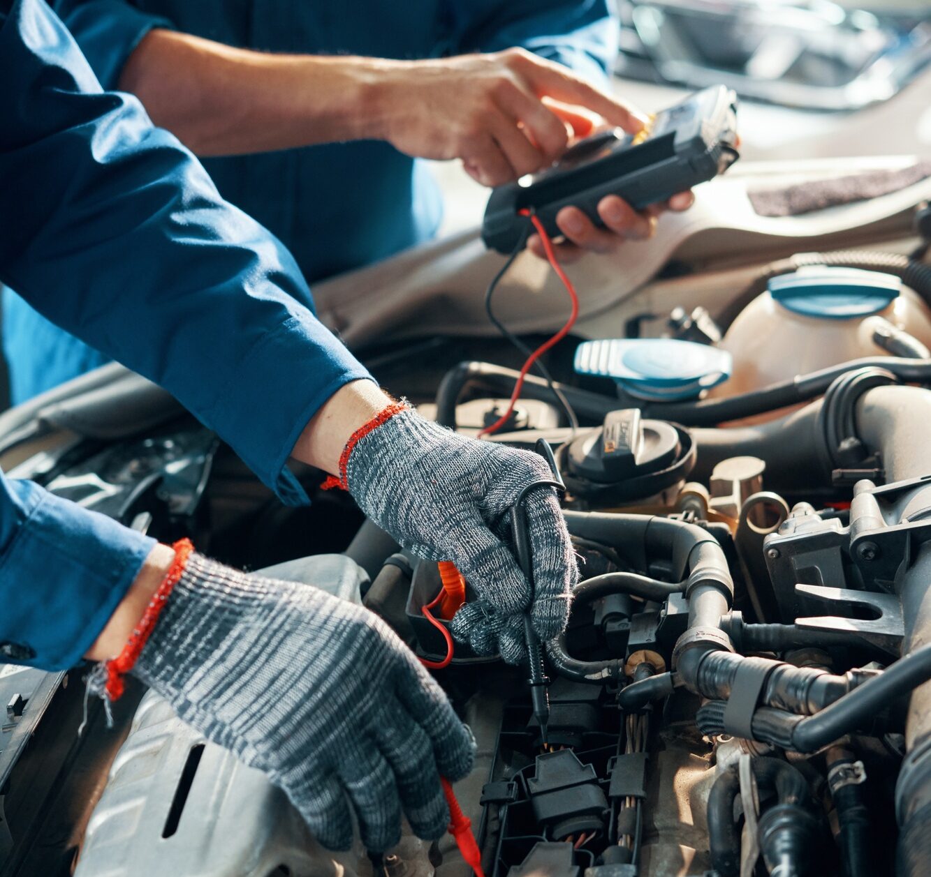 Mechanics testing car motor